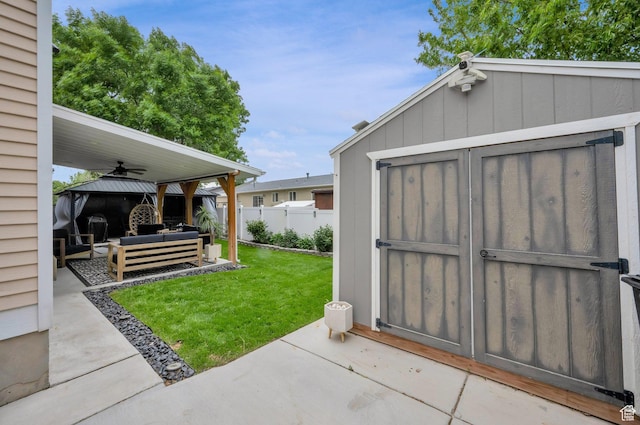 view of yard with an outdoor living space, a gazebo, a storage unit, a patio, and an outbuilding