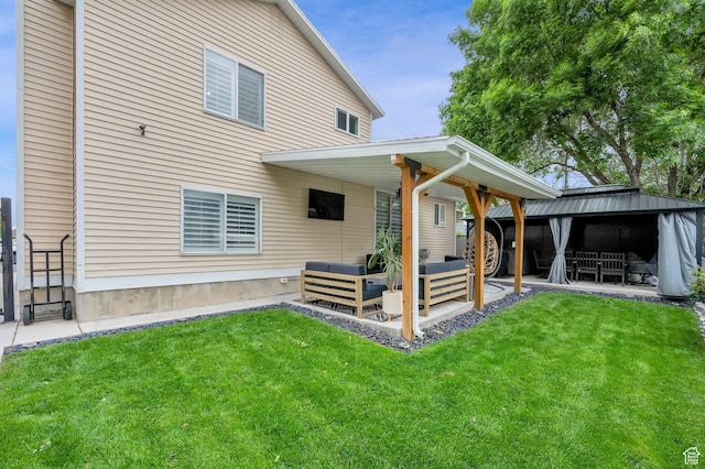 rear view of property with an outdoor hangout area, a patio, a yard, and a gazebo