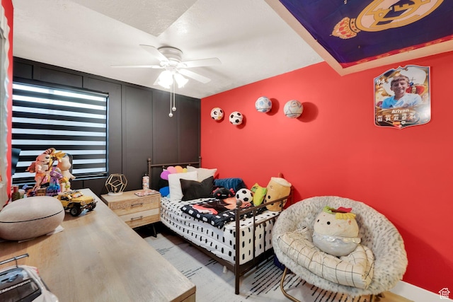 bedroom with a ceiling fan and wood finished floors