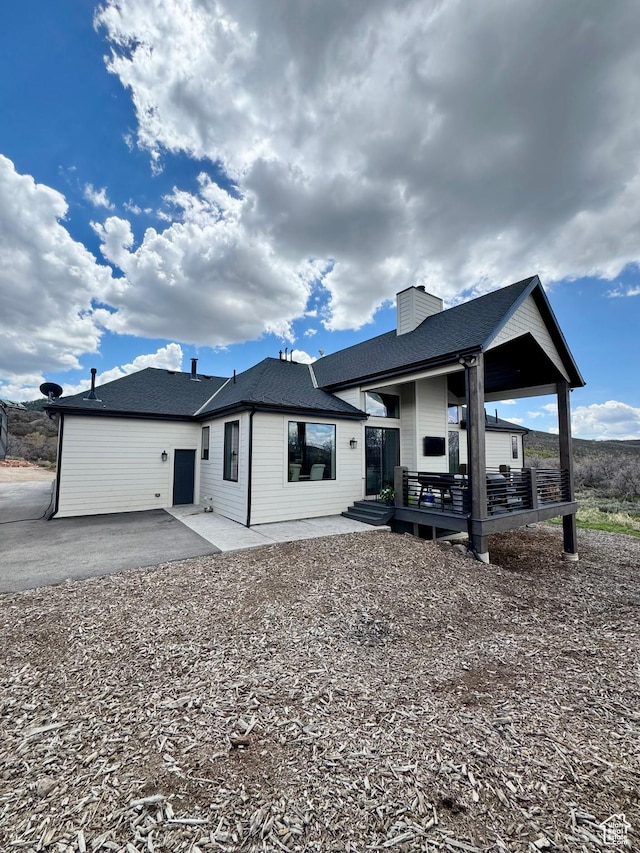 9351 E Acorn Cir Unit 921, Heber City, UT 84032 - rear view of property featuring a chimney, roof with shingles, and a patio area