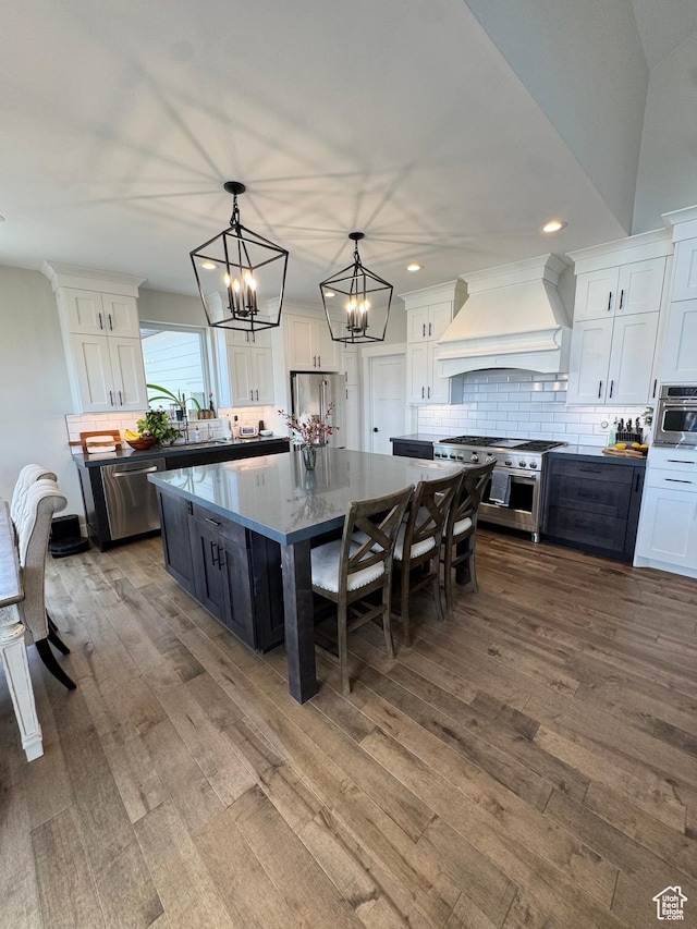 9351 E Acorn Cir Unit 921, Heber City, UT 84032 - kitchen with custom range hood, premium appliances, white cabinetry, a kitchen island, and recessed lighting
