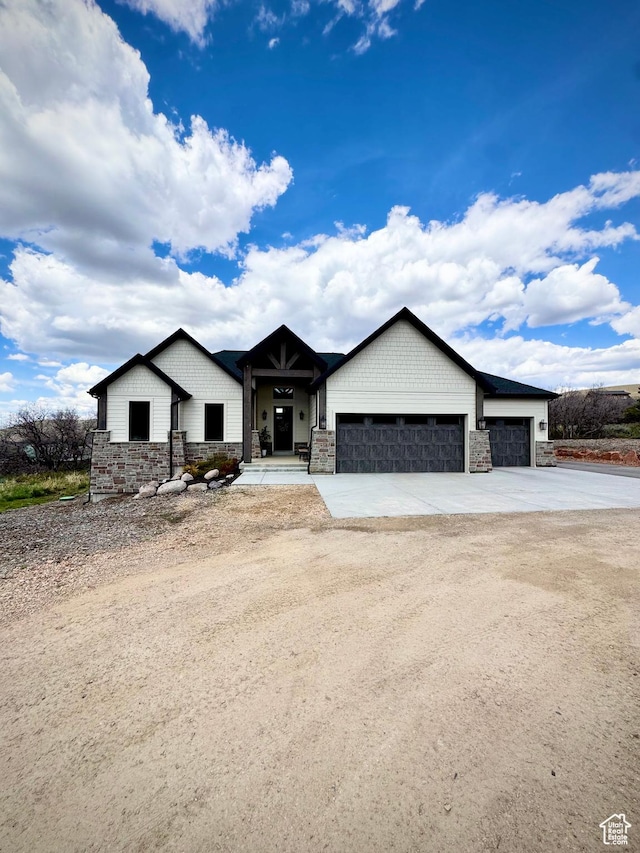 9351 E Acorn Cir Unit 921, Heber City, UT 84032 - view of front of home featuring stone siding, a garage, and concrete driveway