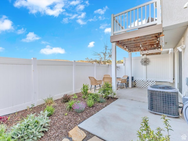 view of patio featuring cooling unit and a fenced backyard