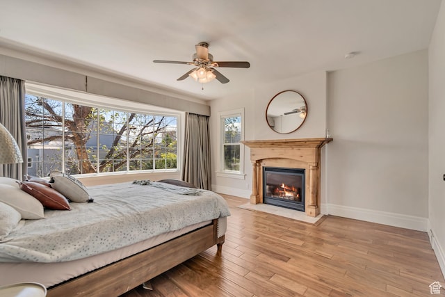 215 E 2nd Ave S, Salt Lake City, UT 84103 - bedroom featuring baseboards, a fireplace with flush hearth, wood finished floors, and a ceiling fan