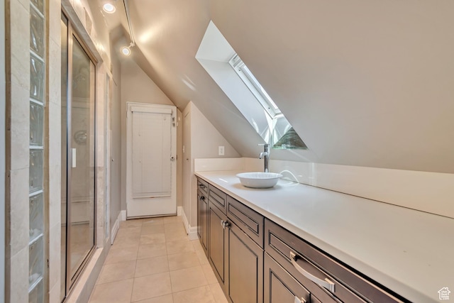 215 E 2nd Ave S, Salt Lake City, UT 84103 - bathroom with a skylight, vaulted ceiling, tile patterned flooring, vanity, and a stall shower
