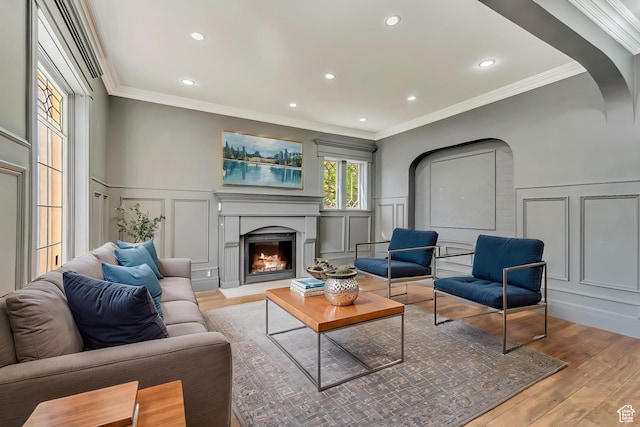 215 E 2nd Ave S, Salt Lake City, UT 84103 - living area featuring a decorative wall, wood finished floors, a lit fireplace, a wainscoted wall, and crown molding