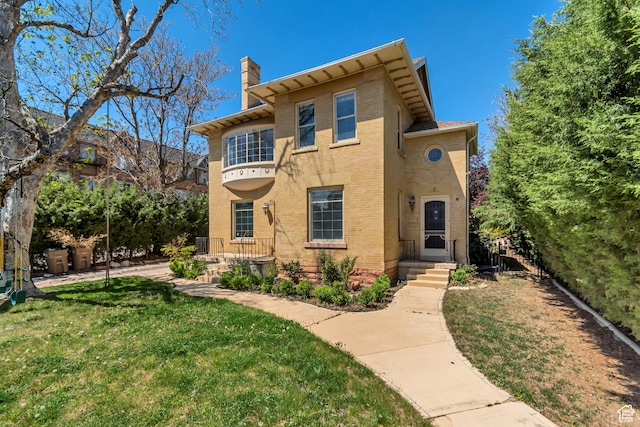 215 E 2nd Ave S, Salt Lake City, UT 84103 - view of front of home featuring a chimney, brick siding, and a front yard