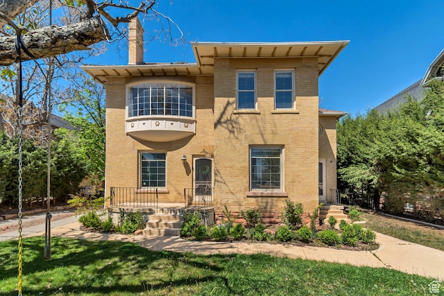 215 E 2nd Ave S, Salt Lake City, UT 84103 - view of front facade featuring a chimney, brick siding, and a front lawn