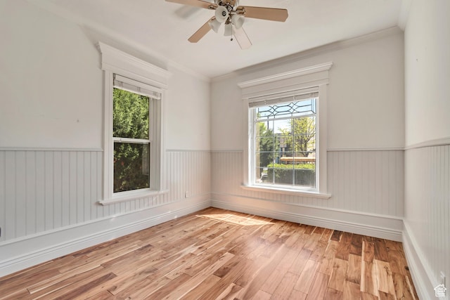 215 E 2nd Ave S, Salt Lake City, UT 84103 - spare room featuring wainscoting, light wood-type flooring, crown molding, and ceiling fan