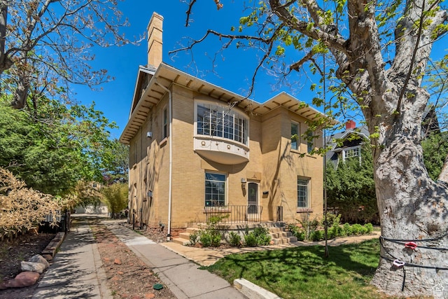 215 E 2nd Ave S, Salt Lake City, UT 84103 - view of front of house with brick siding and a chimney