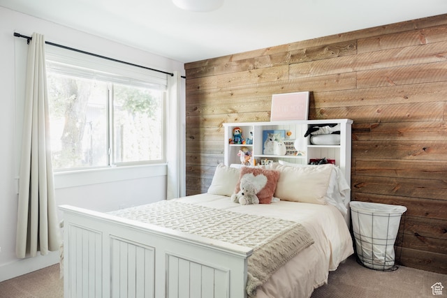 bedroom with carpet and wood walls