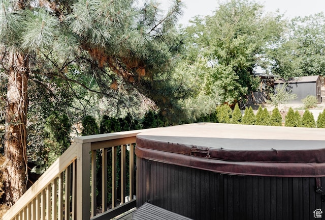 wooden deck with a hot tub