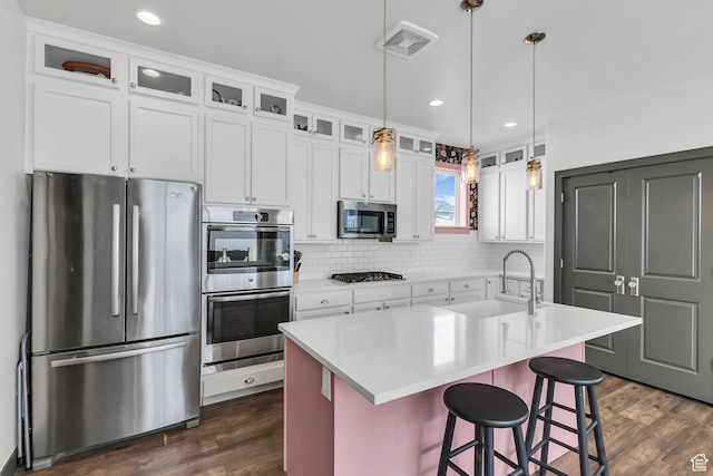 11386 S New Bern Way S, Jordan, UT 84009 - kitchen featuring stainless steel appliances, a sink, dark wood-type flooring, decorative backsplash, and white cabinets