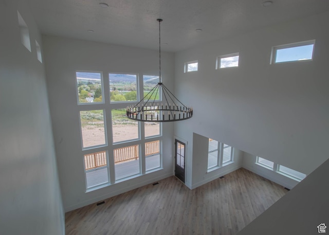 479 S 550 E, Wallsburg, UT 84082 - unfurnished living room featuring baseboards, a chandelier, and wood finished floors