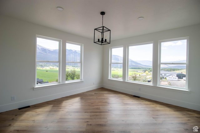 479 S 550 E, Wallsburg, UT 84082 - unfurnished dining area with a chandelier, baseboards, a mountain view, and wood finished floors