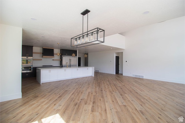 479 S 550 E, Wallsburg, UT 84082 - kitchen featuring open floor plan, stainless steel appliances, light wood finished floors, baseboards, and hanging light fixtures