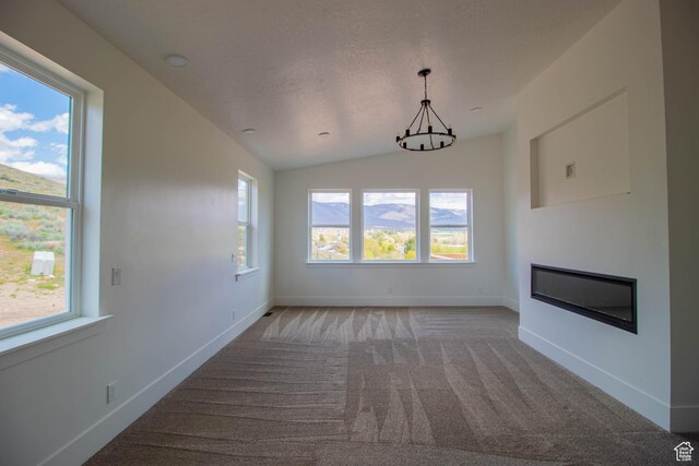 479 S 550 E, Wallsburg, UT 84082 - unfurnished living room with a chandelier, healthy amount of natural light, light colored carpet, baseboards, and vaulted ceiling