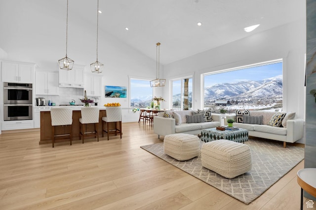 1441 N Jerry Gertsch Ln, Midway, UT 84049 - living area with high vaulted ceiling, light wood finished floors, a chandelier, and recessed lighting