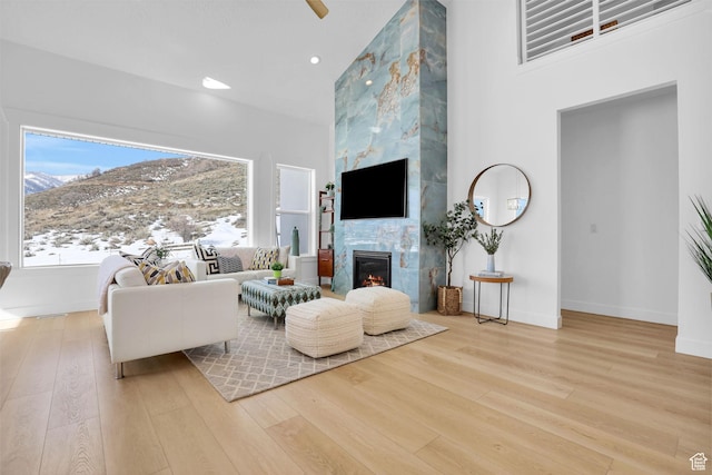 1441 N Jerry Gertsch Ln, Midway, UT 84049 - living area featuring wood finished floors, a mountain view, a tile fireplace, baseboards, and recessed lighting