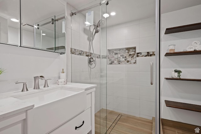 bathroom featuring a shower stall and vanity