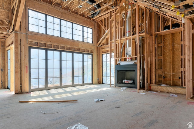 unfurnished living room with a high ceiling