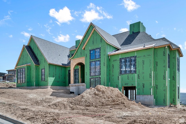 property in mid-construction featuring a shingled roof
