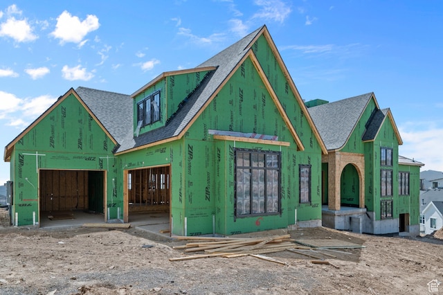 property in mid-construction with roof with shingles