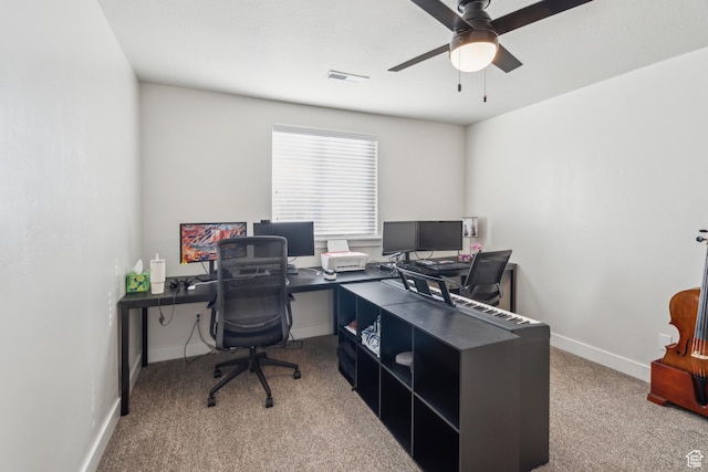 home office featuring carpet floors, ceiling fan, and baseboards