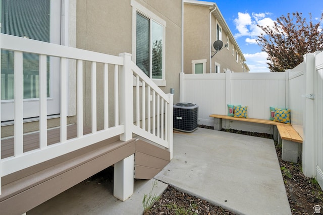 view of patio with fence and central air condition unit