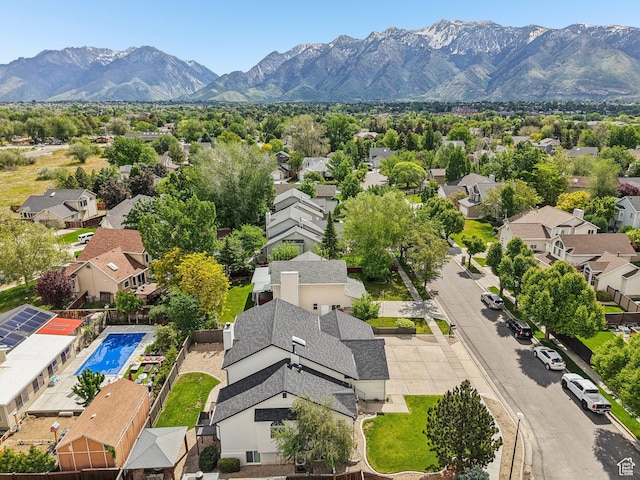 aerial perspective of suburban area with a mountain backdrop and a pool area