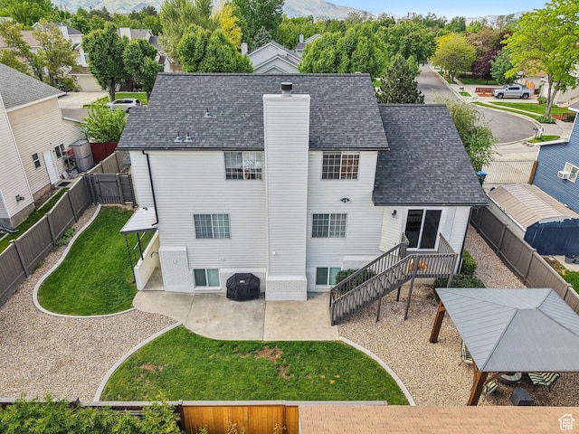 rear view of property featuring a patio, a chimney, and a mountain view