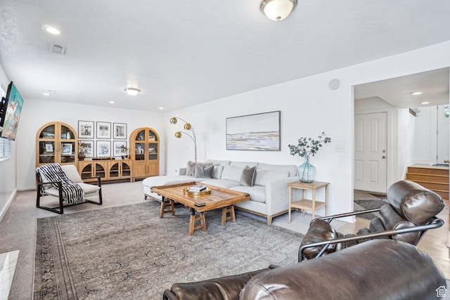 carpeted living room with recessed lighting and baseboards