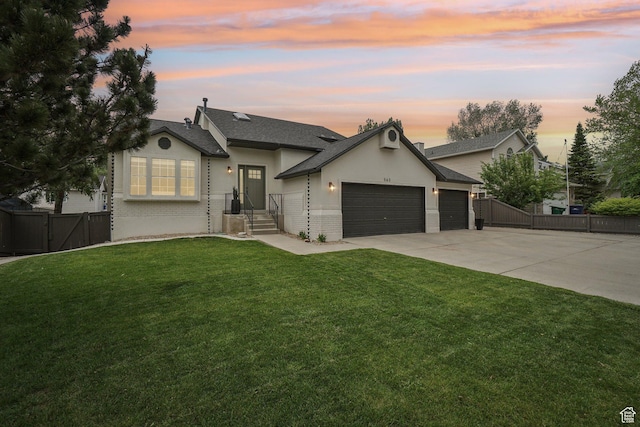 view of front of house featuring a garage, concrete driveway, a gate, a shingled roof, and brick siding
