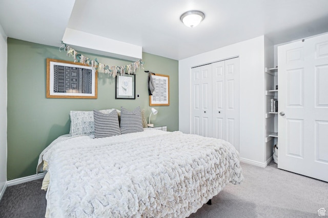 bedroom featuring carpet, a closet, and baseboards