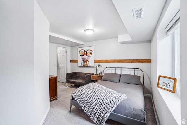 bedroom featuring light carpet and baseboards