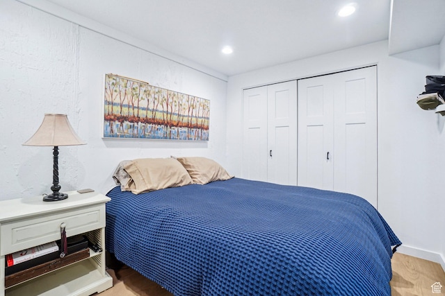 bedroom with a closet, light wood-style floors, and recessed lighting