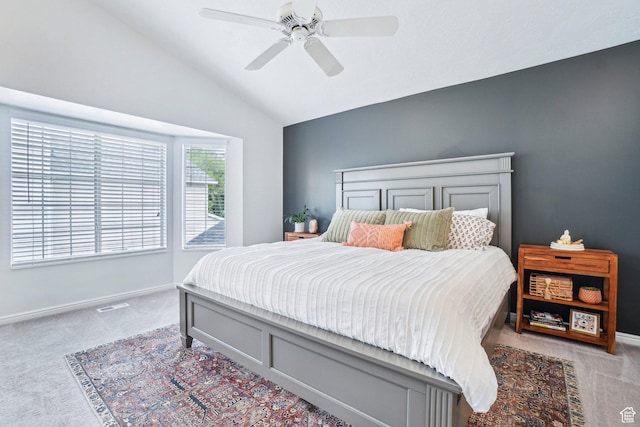bedroom with carpet flooring, vaulted ceiling, baseboards, and a ceiling fan