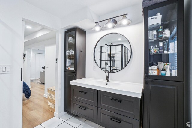 full bathroom with wood finished floors and vanity