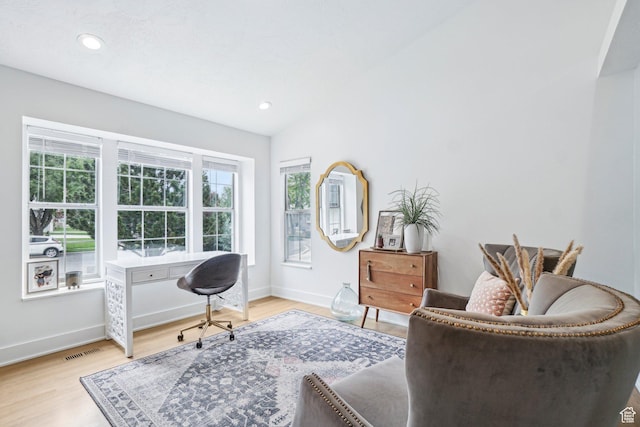 office featuring light wood-type flooring, baseboards, recessed lighting, and lofted ceiling