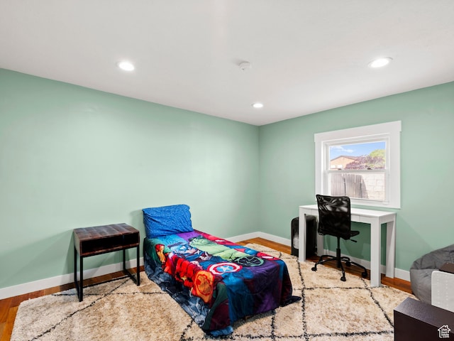 bedroom with baseboards, recessed lighting, and wood finished floors