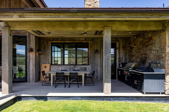 view of patio with a grill, a deck, and outdoor dining area