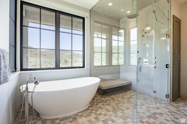 full bathroom with a freestanding tub, a shower stall, recessed lighting, and tile patterned floors