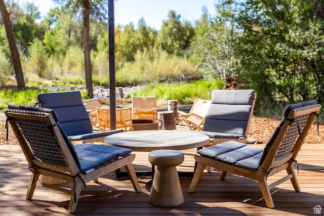 wooden terrace featuring outdoor dining area