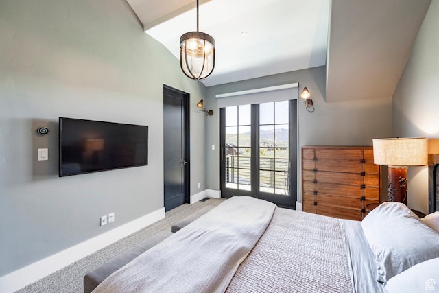 bedroom featuring baseboards, light colored carpet, and lofted ceiling