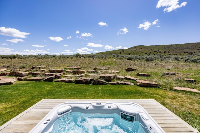 view of pool with a yard and a mountain view