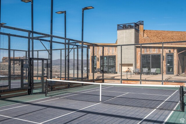 view of tennis court with fence