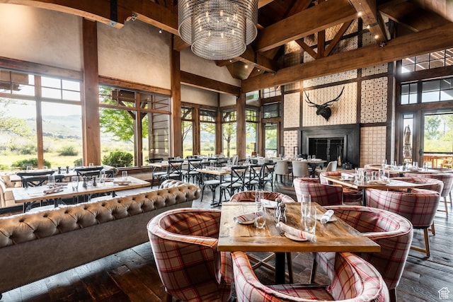 dining room with high vaulted ceiling, beamed ceiling, and hardwood / wood-style flooring