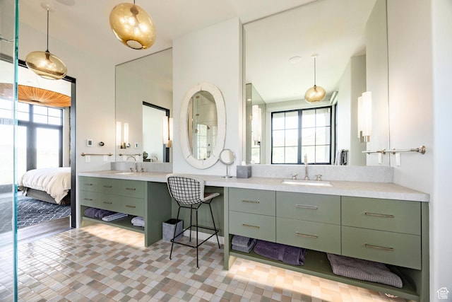 bathroom with vanity and ensuite bath