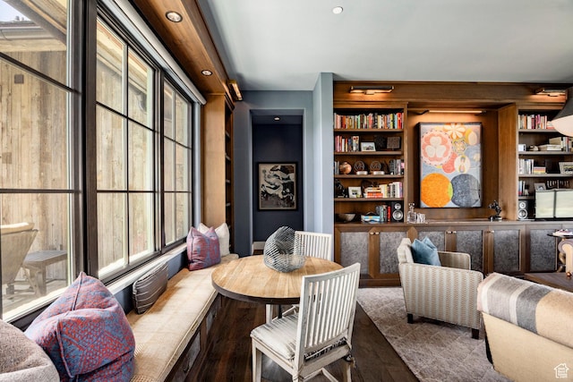 dining space with wood finished floors, built in shelves, and recessed lighting