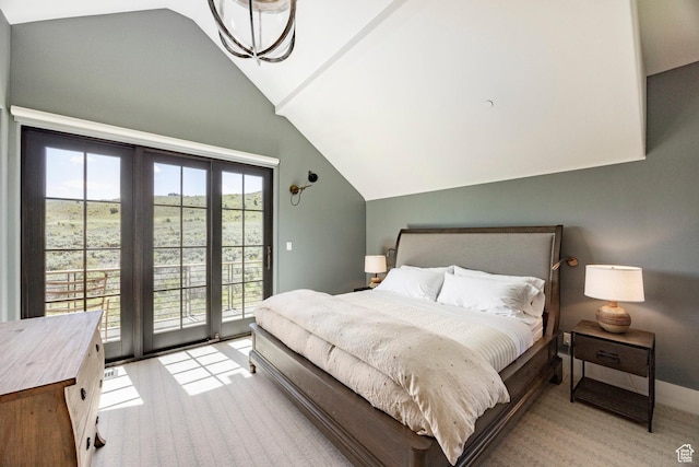 bedroom with vaulted ceiling, access to exterior, and light colored carpet
